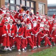 Around 50 people dressed as Father Christmas for a Santa Run in Minehead, despite the wet weather.