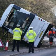 Police at the scene on the A39 Quantock Road as the bus is righted by recovery vehicles.