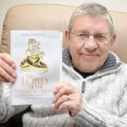 Ron Sheppard holds his book - The Lord of the Wedding Ring.