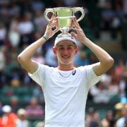 Henry Searle lifts the Wimbledon trophy. Picture: Steven Paston PA