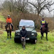 Amanda Hamley Chairperson of West Somerset & Exmoor Bridleways Association with fellow rider Sam, presenting a big cheque (shown on the ENPA vehicle) to Ranger Charlotte Wray.