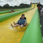 Liberal Democrat leader Ed Davey in a rubber ring on a waterslide with Anna Sabine, the Lib Dem candidate in Frome and East Somerset.
