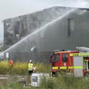 Fire crews using hoses to extinguish the blaze.