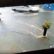 Flash flooding in Glastonbury saw street signage and chairs carried down the road in the rainwater.