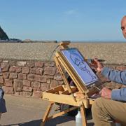 JAY Mitchell poses for beach caricature artist Hamdy Soliman. PHOTO: Somerset Photo News.