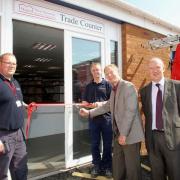 DONALD Rushton, board member, cuts the ribbon with Nicholas Blackshaw (left) and Chris Parsons (right), holding the ribbon and Tony Murray MWS director. PHOTO: Submitted.