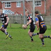 ASSIST: Minehead's Josh Parker puts Chris James for his first of two tries against Stothert and Pitt