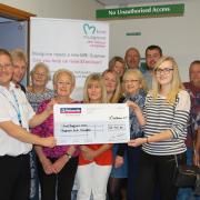 The families of the Power brothers present a cheque to the Love Musgrove scanner appeal in their memory.