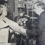 DONATION: The Queen Mother hands over a signed photograph of herself to Lt Col Tony Urwick at the Military Museum