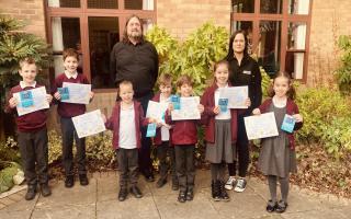 (Back row, left to right) Managing Director of Jasun Envirocare, Colin Hitch and Marketing Assistant, Eloise Day, with children from Puriton Primary School and their certificates and vouchers.