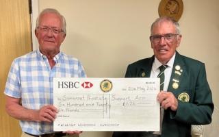 Bowling association president presents cheque to cancer charity